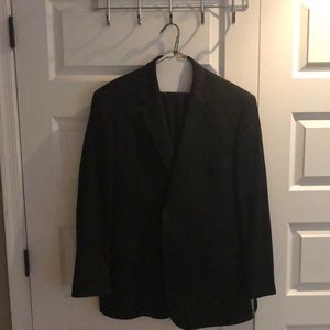 Jos A Bank black suit has feint dark grey stripes.